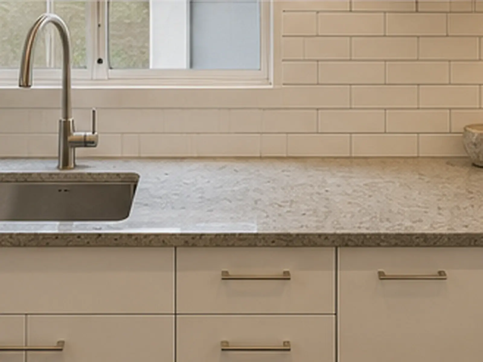 Finished kitchen corner with stone benchtop, new tapware and subway tiles